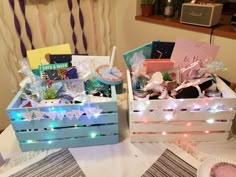 two wooden crates with lights on them sitting on a table next to a bowl and plate