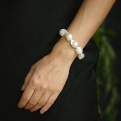 This large baroque pearl bracelet is made of white high luster baroque pearl beads. While making this statement bracelet, I used gold-plated balls on brass at the both ends of the bracelet. The combination of pearls and gold gives this handmade bracelet a classic and timeless look. The closure is 14k gold-plated spring ring.  The clasp and beads at both ends can be chosen in 925 sterling silver. This large pearl bracelet is perfect for formal events, cocktail parties, or a night out. This white natural pearl bracelet serves as the ideal complement to an evening dress, enhancing your overall look with its captivating charm.  ❤️ Designed especially for brides, this wedding bracelet is composed of exquisite freshwater pearls. ❤️ This elegant bridesmaid bracelet is meticulously crafted to perf Wedding Baroque Pearl Chain Bracelet, Baroque Pearl Bracelets For Wedding, Wedding Bracelets In Pearl White Baroque Pearl, Pearl White Baroque Pearl Bracelets For Wedding, Baroque Pearl Wedding Bracelets, Wedding Baroque Pearl Bracelets In Pearl White, Elegant Baroque Pearl Beaded Bracelets For Wedding, Formal Baroque Pearl Drop Bracelet, Handmade White Bracelets With Baroque Pearls