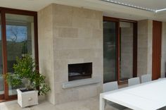 a white table and chairs in front of a fireplace