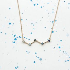 The Cassiopeia constellation has a recognizable "W" shape made up of five bright stars. The stars are represented in this necklace by 5 blue gemstones: an aquamarine, a light blue sapphire, a blue diamond, a London blue topaze and a deep blue sapphire. They are set in and connected with 14 karat gold sections. The constellation necklace is mounted on a 16 inches long 14k gold chain. Cassiopeia Constellation, Constellation Jewelry, Light Blue Sapphire, Constellation Necklace, Ethical Jewelry, Bright Stars, Bracelet Collection, Blue Gemstones, London Blue