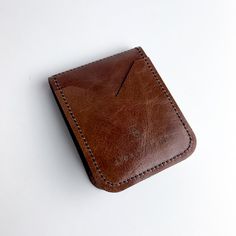 Our perfect Everyday wallet --- updated design with a few extra pockets. Carry cash + cards effortlessly with our very slim, single fold wallet. Classic Trifold Wallet With Card Slots For Everyday, Trifold Wallet With Card Slots For Everyday Use, Classic Bifold Wallet For Personal Use, Everyday Trifold Wallet With Card Slots, Classic Brown Card Holder With Phone Sleeve, Bifold Wallet With Hidden Phone Sleeve For Daily Use, Classic Bifold Card Holder For Everyday Use, Brown Bifold Wallet With Hidden Phone Sleeve, Classic Rectangular Trifold Wallet For Personal Use