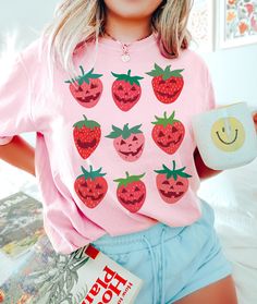 Strawberry Shirt Comfort Colors Halloween Shirt Please send a message if your desired color, size or garment style/brand is not available! Be sure to check the size chart within the listing. Most of the models are wearing oversized apparel. Size up from your usual size to achieve this look! TEE INFO/CARE: * Garment Dyed 100% cotton * Pre-Shrunk * Unisex, Loose fit * Wash inside out in COLD water * Lay flat to dry or machine dry on LOWEST setting * Iron on low * Do NOT dry clean Printed with eco- Playful Pre-shrunk Tops For Halloween, Red Graphic Print Shirt For Halloween, Red Shirt With Graphic Print For Halloween, Red Halloween Crew Neck Shirt, Red Crew Neck Shirt For Halloween, Halloween Pink T-shirt With Screen Print, Pink Halloween T-shirt With Screen Print, Fun Halloween Short Sleeve Shirt, Cute Orange Tops With Cartoon Print