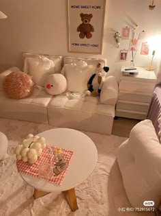 a living room filled with white furniture and pillows