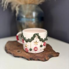 a white coffee cup sitting on top of a wooden tray