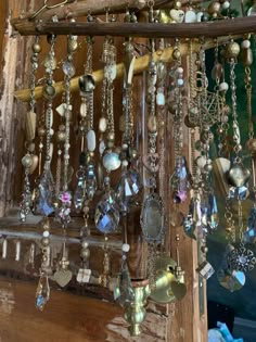 a bunch of necklaces hanging from a wooden rack