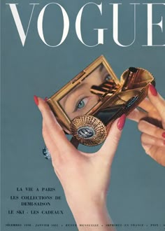 a magazine cover with an image of a woman's face holding a ring and purse