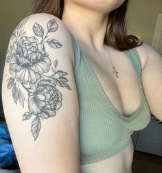 a woman with a flower tattoo on her arm