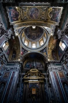 the inside of a church with paintings on the walls