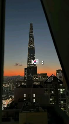 a view of the top of a building at night from a window in an office building