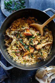 a pan filled with rice and vegetables on top of a table