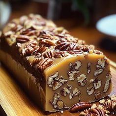 a piece of pecan bar sitting on top of a wooden cutting board