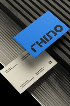 a blue business card sitting on top of a piece of metal