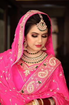 a woman wearing a pink bridal outfit