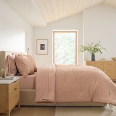 a bedroom with a bed, dresser and window in it's centerpieces