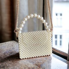 Explore our exquisite collection of handmade bags, featuring unique designs perfect for any occasion. Elevate your style with our elegant Women's Bag, ideal for weddings and special events. Our White Pearl Handbag is a luxurious accessory that adds a touch of sophistication to your ensemble. Whether you're a bride looking for the perfect bag or searching for a Valentine's Day gift, our range of trendy and carefully crafted bags ensures you stand out at any evening party. Embrace the allure of ou Rectangular Evening Bag With Pearl Embroidery For Gift, Top Handle Clutch For Mobile Phone As Gift, Top Handle Mobile Phone Clutch Bag As Gift, Rectangular Pearl Embroidery Evening Bag As Gift, Rectangular Pearl Embroidery Evening Bag, Square Evening Bag With Phone Holder As Gift, Square Shoulder Bag With Pearl Handle As Gift, Beaded Clutch Shoulder Bag For Gifts, Pearl Handle Tote Bag For Gift