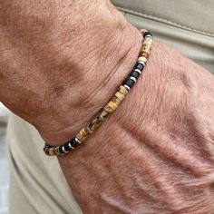 Men's beaded bracelet features: ~ 4mm Picture Jasper heishi beads ~ 4mm Bronzite heishi beads ~ 4mm Stainless Steel spacer beads ~ Stretchy cord; simply slide bracelet on and off wrist ~ Comes packaged in a re-usable microfiber pouch. To ensure the perfect fit, please use the bracelet sizing instructions found in the photo gallery. Organic Accessories, Heishi Bracelet, Jasper Bead Bracelet, Coconut Wood, Slide Bracelet, Mens Beaded Bracelets, Picture Jasper, Heishi Beads, Spacer Beads