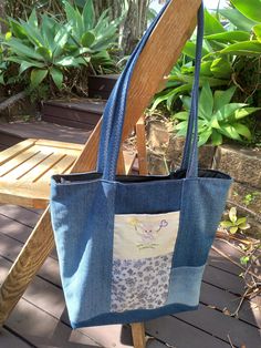 Tote bag made from reclaimed denim and fabric remnants features an embroidered picture and an internal pocket featuring the same character as the front, has three pockets  all together. measurements 33cm hight 30cm wide 9cm side Denim Blue Cotton Shoulder Bag With Double Handle, Denim Blue Cotton Shoulder Bag With Zipper Pocket, Denim Blue Cotton Bag With Zipper Pocket, Denim Blue Cotton Tote Shoulder Bag, Casual Cotton Patchwork Bag, Upcycled Cotton Tote Shoulder Bag, Blue Cotton Bags With Zipper Pocket, Blue Cotton Bag With Zipper Pocket, Cotton Patchwork Tote Bag