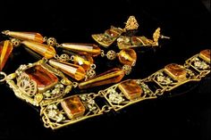 "This is a very beautiful, old and unique ART NOUVEAU NEIGER CZECH CRYSTAL BRASS ENAMEL c, 1920 bracelet and necklace set. The set has a marvelous Art Nouveau style, enamel, flower decoration, faceted citrine crystal, brass. The set has a very extravagant and elegant feel to it. The bracelet measures 7 1/4\" x 3/4\", necklace 15 3/4\" long and 1 1/2\" x 1\" center. The set is in very good condition. 0.7 BR"