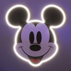 a close up of a mickey mouse head with glowing lights on it's face