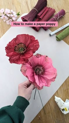 someone is making paper flowers on the table