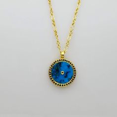 SIGNATURE TURQUOISE GOLD NECKLACE Luxury Turquoise Pendant Jewelry, Luxury Turquoise Round Necklace, Luxury Round Turquoise Necklace, Blue Medallion Jewelry With Adjustable Chain, Turquoise Necklace With Round Natural Stone Pendant, Luxury Turquoise Pendant Necklace, Luxury Blue Turquoise Gemstone Necklace, Turquoise Round Gold-plated Jewelry, Blue Coin Pendant Jewelry