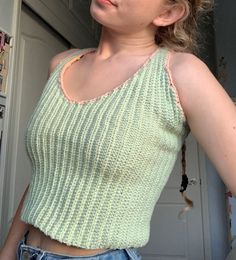 This top is the perfect statement piece for any warm weather outfit, and the vertical ribbing is super flattering! This top took me about two weeks to crochet, and is made out of the sweetest light green cotton yarn. The straps criss cross in the back, and create a cute little keyhole cutout. The green is outlined with a light pink trim, which makes this top even more spring-y :) Green Ribbed Knit Top For Spring, Green Knit Top For Spring, Spring Green Knit Top, Green Cotton Knit Top For Spring, Summer Green Knit Top, Casual Green Crochet Top, Green Knit Fitted Top, Green Casual Crochet Top With Knit Fabrication, Casual Green Crochet Top With Knit Fabrication