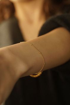 Introducing the Satellite Bracelet--a delicate and enchanting piece that gracefully adorns your wrist with understated elegance. Embrace the beauty of simplicity with this dainty chain bracelet that exudes charm and sophistication. 14k Gold Filled Bracelet Width - 1.2mm Extender - 1 inch If you would like a custom length, please don't hesitate to ask. We are more than happy to make one for you. All items come packaged in a gift box ready to give as a gift or keep for yourself. Gold-filled jewellery is a more affordable alternative to solid gold jewellery while still offering a similar appearance and durability. The thick layer of gold provides a long-lasting and tarnish-resistant finish so you can have pieces that will last. Our boxes are ECO friendly and FSC certified. FSC stands for Fore Delicate Adjustable Jubilee Chain Bracelet, Adjustable Delicate Chain Charm Bracelet, Dainty Round Chain Bracelet For Party, Adjustable Bracelet With Satellite Chain And Round Beads, Delicate Chain Bracelet For Party, Everyday Tiny Beads Chain Bracelet, Delicate Party Chain Bracelet, Delicate Adjustable Chain Bracelet With Tiny Beads, Dainty Beaded Bracelets With Satellite Chain