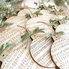 several pieces of paper with leaves and music sheets attached to them, sitting on top of sheet music