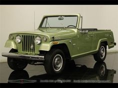 a green jeep is parked in a room