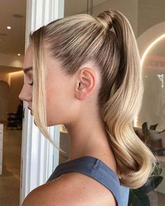 a woman with blonde hair in a ponytail