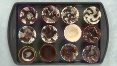 twelve cupcakes are arranged on a baking tray