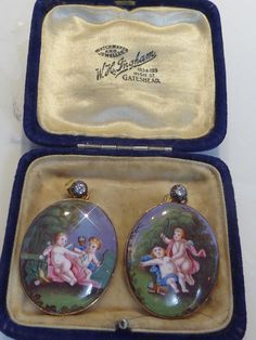 A stunning pair of antique hand painted enamel real diamond(tested) set in rose gold framed earrings. both oval enamel panels are set in rose gold and suspend from solitaire diamond mounts. stunning when worn. solid gold not plated. butterfly fittings to back. in excellent condition. measure 3.6cm drop x 2.5cm wide. Elegant Enamel Cameo Jewelry, Antique Enamel Earrings For Gift, Antique Enamel Earrings As Gift, Ornate Oval Enamel Jewelry, Bat Earrings, Rose Gold Frame, Oval Locket, Silver Cat, Emerald Pendant