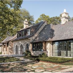 a large brick and stone house in the middle of a park