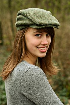 a young woman wearing a green hat in the woods