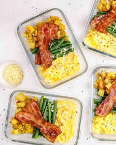 four plastic containers filled with food on top of a white countertop next to eggs and green beans