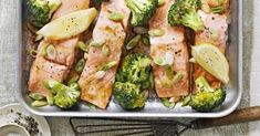 salmon and broccoli in a pan with lemon slices