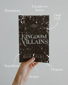 a hand holding up a book with the words kingdom villain's written on it