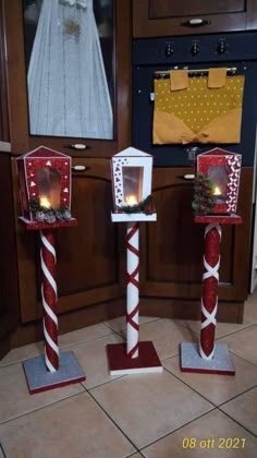 two red and white candlesticks with lights on them