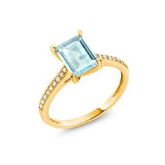 a gold ring with an aqua blue topazte and diamonds on the sides, set in