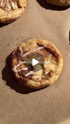 several cookies with icing on them sitting on top of a baking sheet in the sun