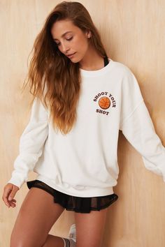 This oversized graphic sweatshirt features a basketball inspired designed crafted on a lighter weight fleece lined sweatshirt. Perfect for a post workout layering piece or your favorite outdoor activity on a chilly day, this sweatshirt combines style and performance. Sweatshirt Photography Ideas, Oversized Sporty Crew Neck Sweatshirt, Oversized Crew Neck Sweats For Sports Season, Sporty Drop Shoulder Tops For College, Sporty Fleece Sweatshirt With Drop Shoulder, Throwback College Sweatshirt With Relaxed Fit, Relaxed Fit Throwback Sweatshirt With Graphic Print, Athleisure Sweats With Graphic Print For Winter, Throwback Relaxed Fit College Sweatshirt