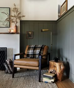 a living room filled with furniture and a clock on the wall above it's fireplace