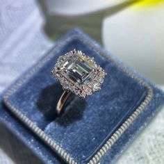 an engagement ring in a blue velvet box