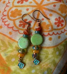 Colors of carnelian, turquoise, green, brown and mango make these very close to the amazing sunsets we have here in the desert.  I added a funky little geometric charm to finish the design.  A great all round pair of earrings, can be paired with many outfits. Green Artisan Round Bead Earrings, Green Copper Bead Earrings, Green Copper Round Bead Earrings, Artisan Green Czech Glass Earrings, Bohemian Jade Earrings, Artisan Adjustable Green Beaded Earrings, Green Spiritual Jewelry With Dangling Beads, Bohemian Jade Earrings With Ear Wire, Nickel Free Bohemian Jade Earrings