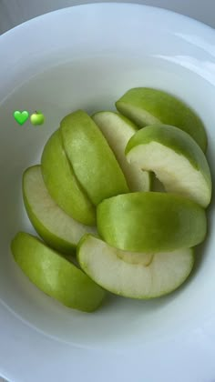 sliced apples in a white bowl on a table