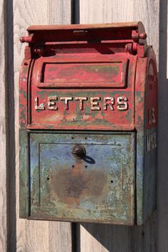 an old red mailbox with the words letters written on it