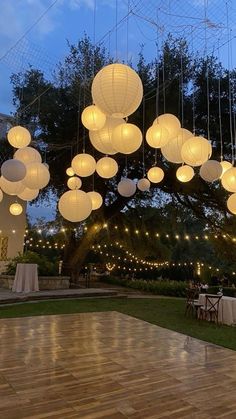 an outdoor dance with paper lanterns hanging from the ceiling and string lights strung across the floor