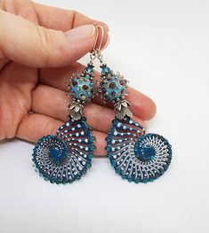 These Stunning teal Ammonite earrings are flameworked enamel on copper and accented with absolutely beautiful lampwork glass beads that remind me of sea urchins. They are topped with Swarovski crystals. Even though the Ammonites and beads are made by two different artists, the color match is incredible! These earrings are approx. 3.5 inches long, including the sterling silver lever backs. Last photo posted shows the back of the earrings are dark gray enamel.  The ammonites are flameworked glass (enameled) on copper and are not bendable! If bent the enamel will break. Please do not toss them in a jewelry box with other jewelry. I would suggest storing them separate from other jewelry. I will be carefully packaging them in a gift box for you.  These earrings are handmade and One of a Kind. Ammonite Earrings, Sea Urchins, Different Artists, Lampwork Glass Beads, Earrings Handmade, Color Matching, Dark Gray, Jewelry Earrings Dangle, Swarovski Crystals