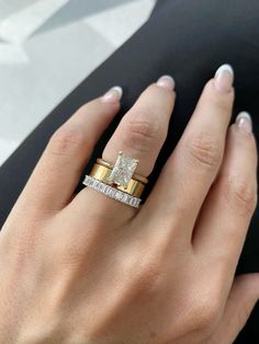 a woman's hand with two different rings on her left and the other one has a diamond in it