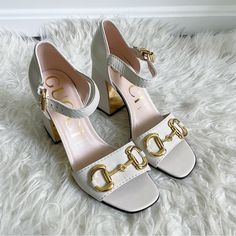 Gucci Baby Horsebit Ivory Block Heel Leather Ankle Strap Sandal Size 38 New White Leather Horsebit Block-Heel Sandals From Gucci Featuring Open Toe, Branded Insole, Tonal Stitching, Signature Horsebit Detail, Gold-Tone Hardware, Buckle-Fastening Ankle Strap And High Block Heel. Comes With Dust Bags 100% Authentic 655411 Gucci Chic Low Heel Heels, Gucci Low Heel Shoes With Heel Strap, Elegant Gucci Heels For Spring, Chic Gucci Heels For Summer, Chic Gucci Low Heel Heels, Chic Formal Sandals With Gold Buckle, Chic Gucci Heels For Spring, Elegant Gucci Sandals For Spring, Gucci Sandals With Buckle And Block Heel